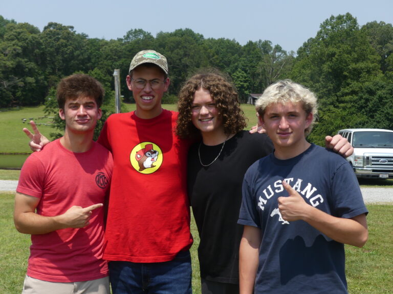 A group of young men standing together outside.